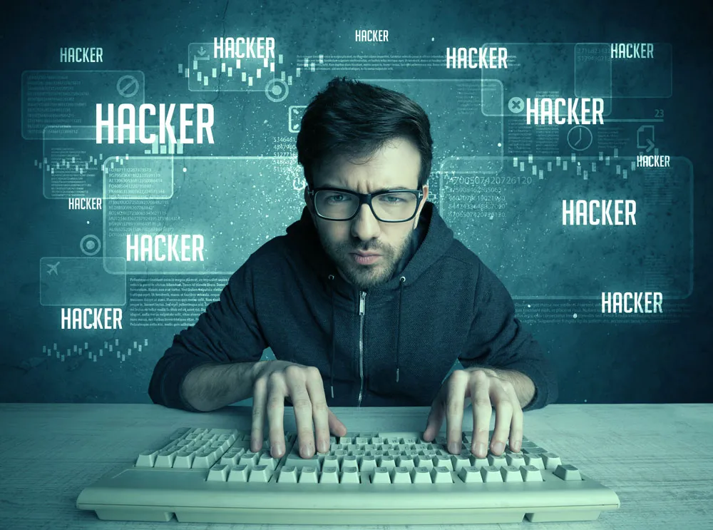 Man typing on a keyboard with a serious expression, surrounded by digital elements and the word "HACKER" prominently displayed, illustrating themes of cybersecurity and hacking relevant to computer repair services.