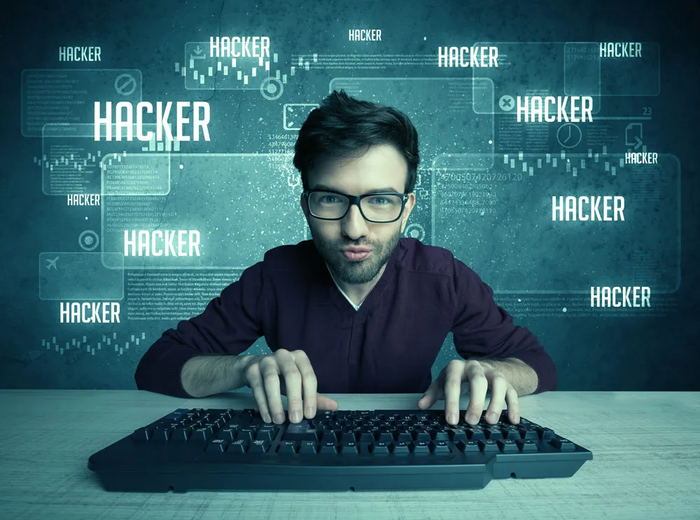 Man typing on a keyboard with "HACKER" text overlay, representing computer security and hacking themes relevant to virus removal and hacked computer repair services in Broken Hill.